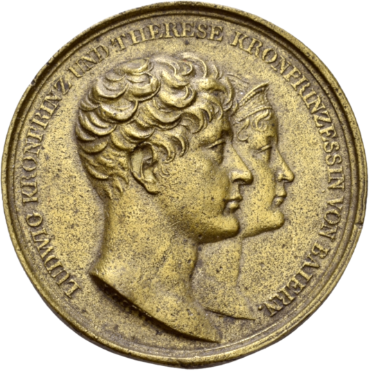 Eine blass goldfarbene Medaille mit dem Profil eines jungen Paares. 