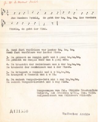 Eine Seite aus einem Buch, die einen Liedtext und Noten dazu zeigt.